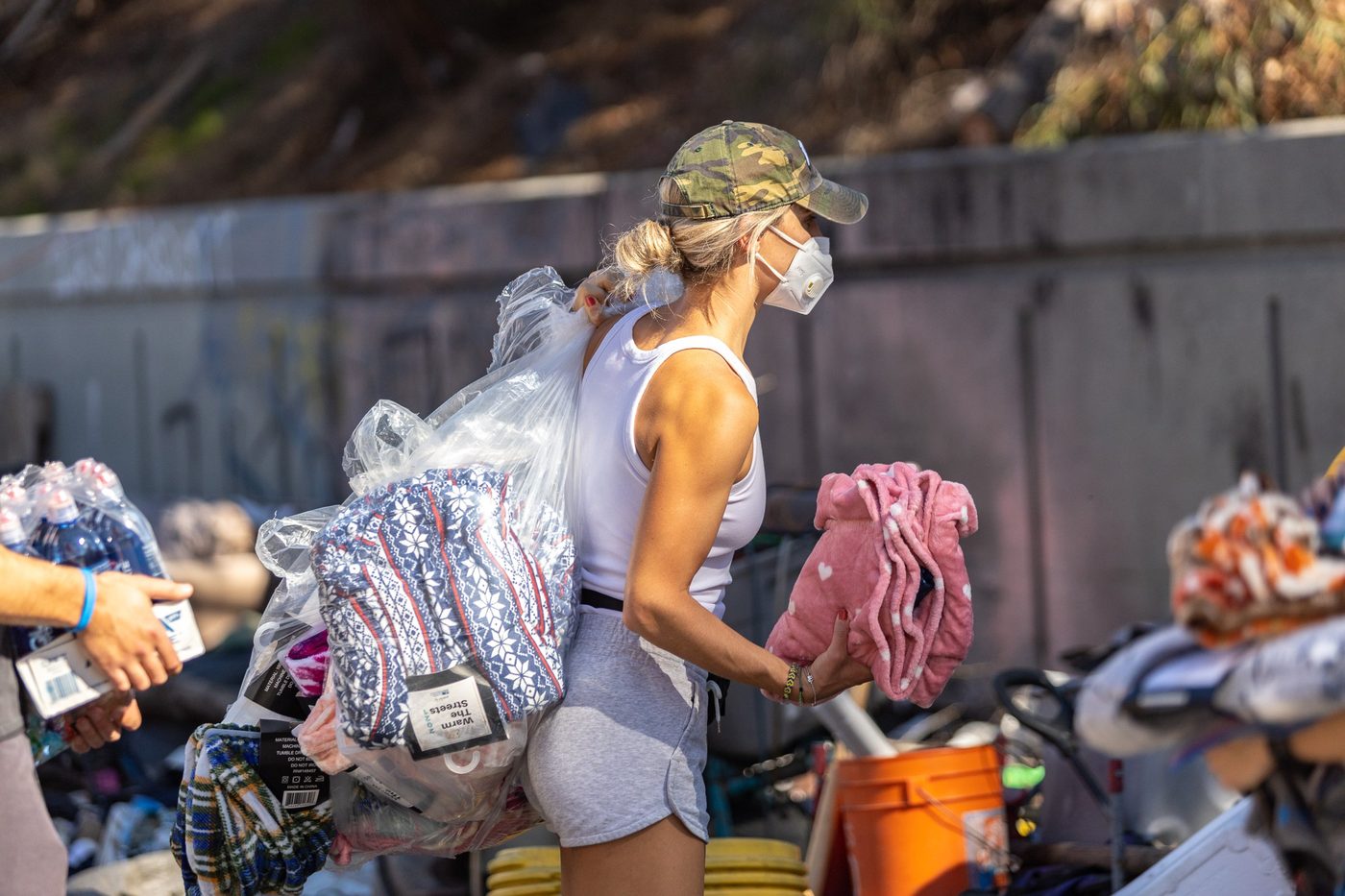 A Warm the Streets volunteer carrying blankets and water on an outreach route